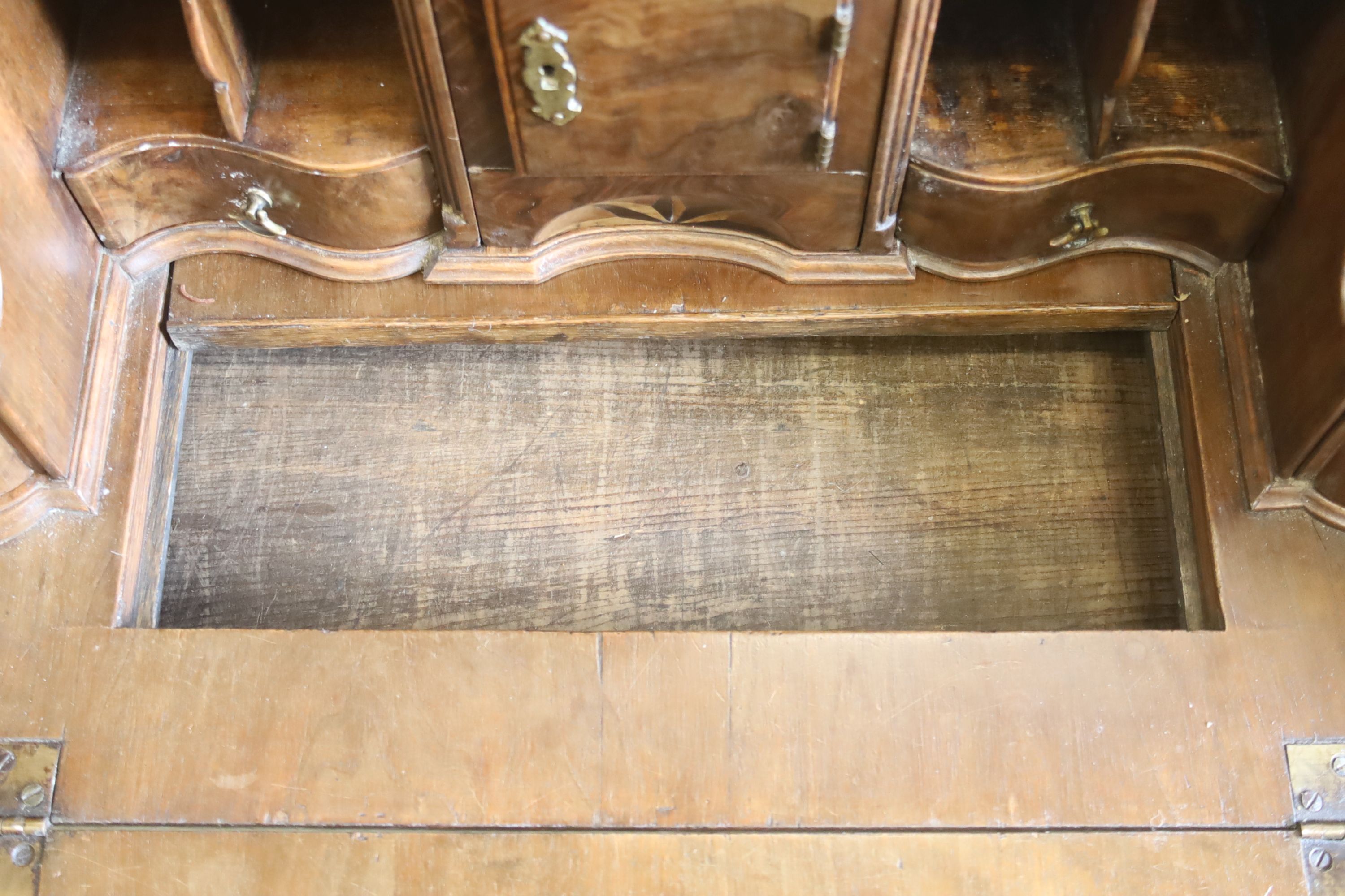 A Queen Anne style walnut double domed top bureau bookcase, length 72cm, width 50cm, height 196cm